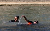Paris mayor dips into Seine River before Olympics