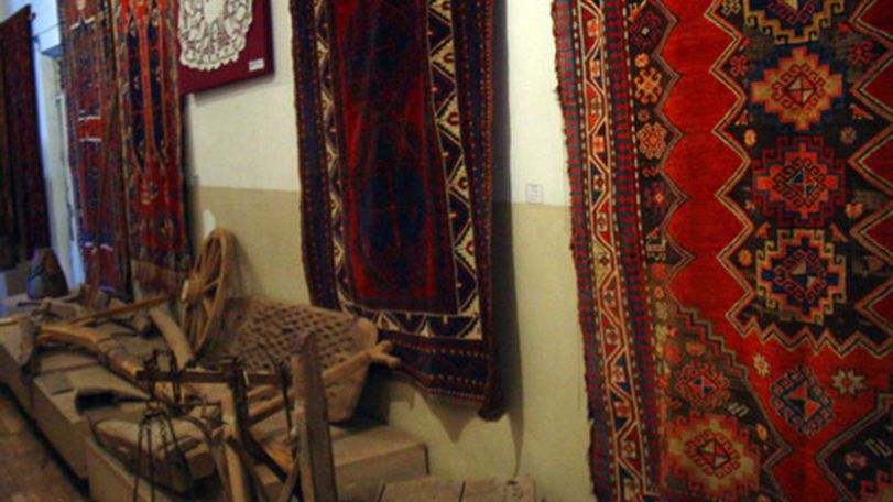 Open air exhibition in Gegharkunik province. Tourists interested in carpet weaving exhibits