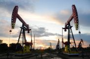 Oil drops after U.S. inventory build, new output record