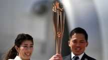 Greece hands Olympic flame over to Japan amid calls to delay 2020 Games