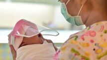 Babies given tiny face shields in bid to stop spread of coronavirus in Bangkok