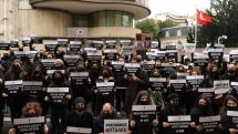 Dozens of protesters in black rally outside the Turkish Embassy in Paris