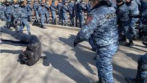 Police officers push media representative to the ground at opposition protest in Yerevan