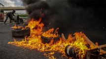 Lebanese protesters block main roads to Beirut in seventh day of protests