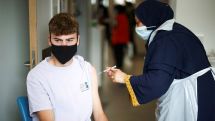 Early signs COVID-19 vaccines may not stop Delta spread, England says