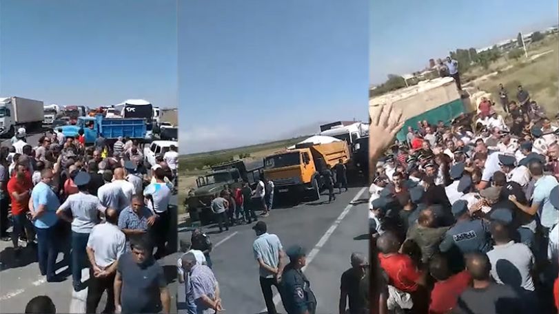 Police officers use force to open interstate road blocked by farmers
