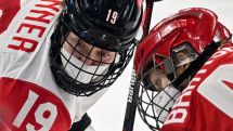 Russian, Canadian women's hockey players wear masks during match