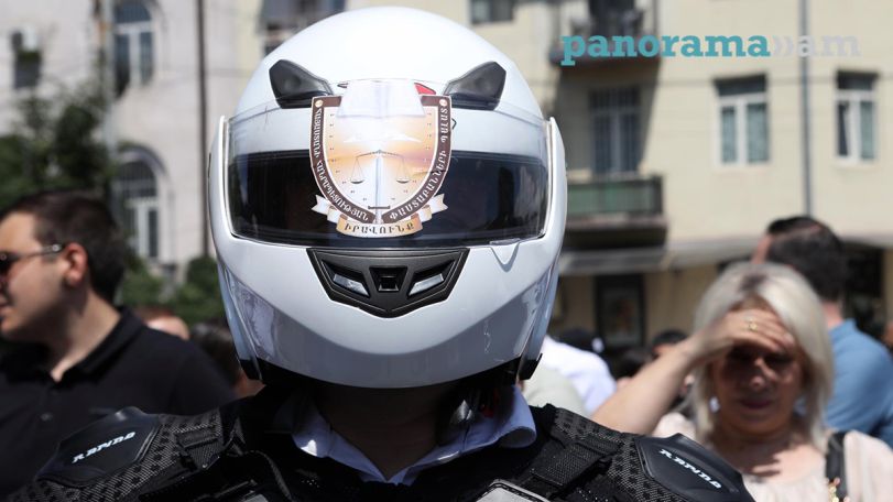 Lawyer joins protest outside Armenia's Interior Ministry wearing body armor, helmet